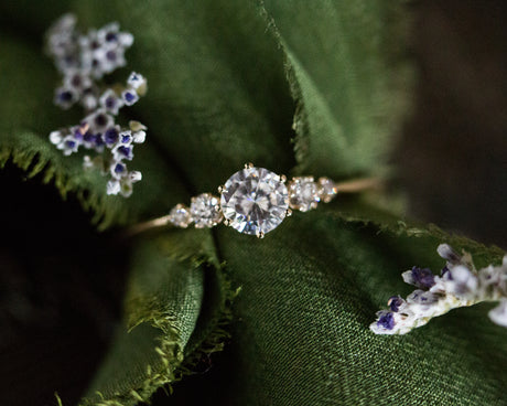 Moissanite with round diamond side stones, five stone ring