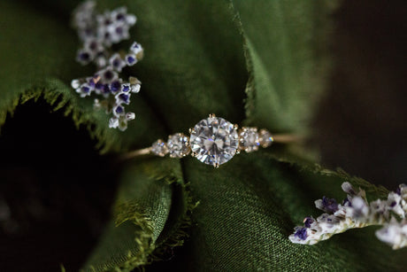 Moissanite with round diamond side stones, five stone ring