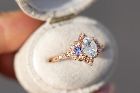 Aurora three stone with oval moissanite and tanzanite