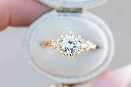 Briar rose three stone with 6.5mm round moissanite and marquise side stones