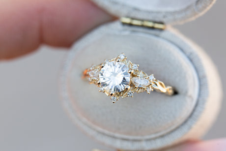 Briar rose three stone with 6.5mm round moissanite and marquise side stones