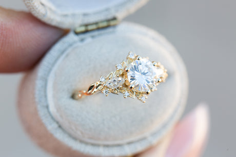 Briar rose three stone with 6.5mm round moissanite and marquise side stones