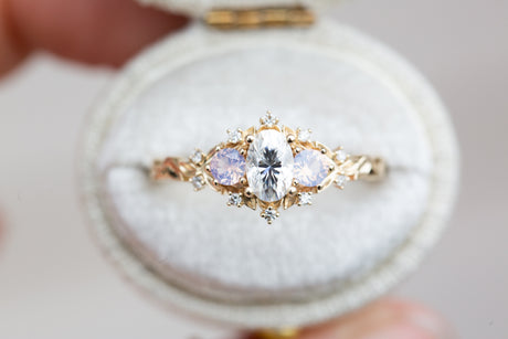 Briar rose three stone with oval moissanite and opalescent sapphires