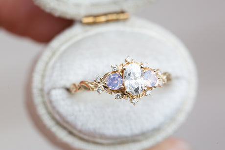 Briar rose three stone with oval moissanite and opalescent sapphires