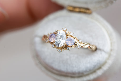 Briar rose three stone with oval moissanite and opalescent sapphires