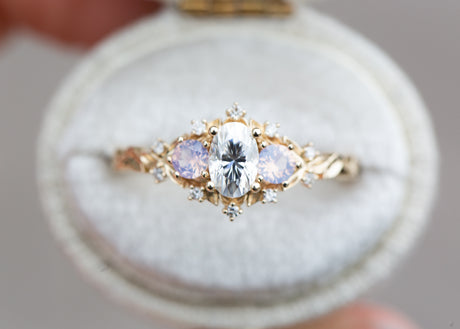Briar rose three stone with oval moissanite and opalescent sapphires