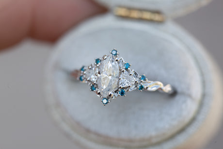 Briar rose three stone with marquise moissanite and irradiated blue diamonds