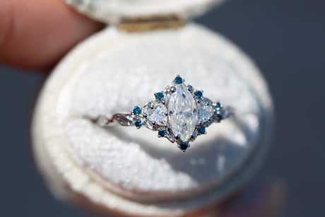 Briar rose three stone with marquise moissanite and irradiated blue diamonds