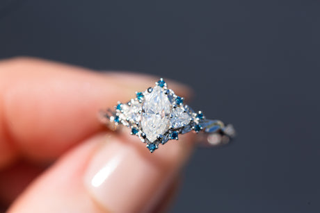 Briar rose three stone with marquise moissanite and irradiated blue diamonds