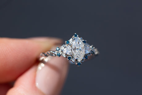 Briar rose three stone with marquise moissanite and irradiated blue diamonds