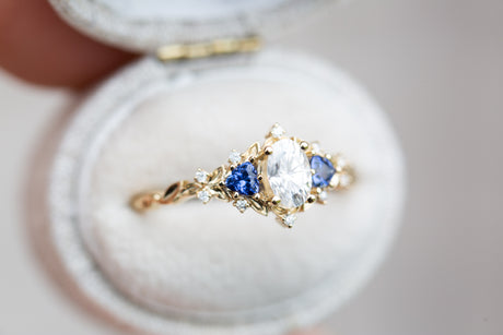 Briar rose three stone with oval moissanite and blue sapphire