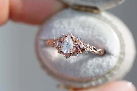 Briar rose three stone with pear moissanite and peach sapphire side stones