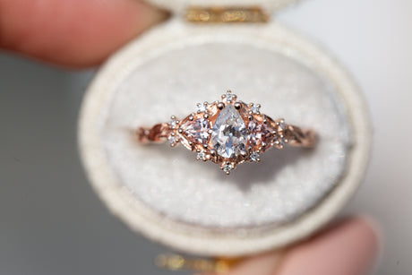Briar rose three stone with pear moissanite and peach sapphire side stones