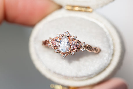 Briar rose three stone with pear moissanite and peach sapphire side stones