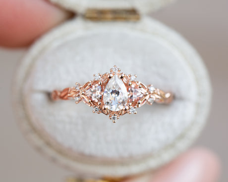 Briar rose three stone with pear moissanite and peach sapphire side stones