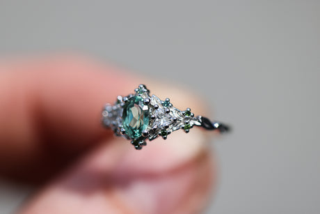 Briar rose three stone with oval lab green sapphire and green diamond accents