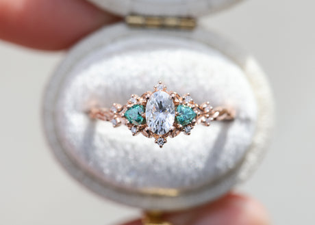 Briar rose three stone with oval moissanite and teal moissanite side stones
