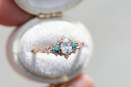 Briar rose three stone with oval moissanite and teal moissanite side stones