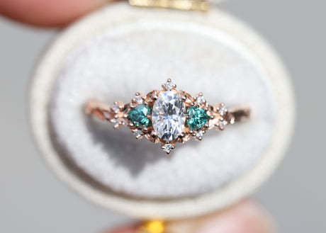 Briar rose three stone with oval moissanite and teal moissanite side stones