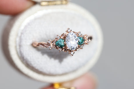 Briar rose three stone with oval moissanite and teal moissanite side stones