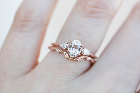 Oval moissanite three stone engagement ring, pear side stone