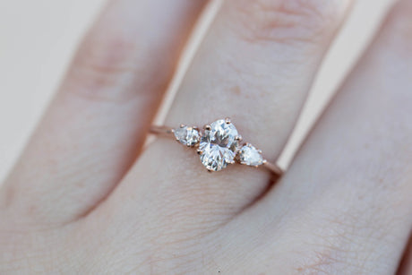 Oval moissanite three stone engagement ring, pear side stone