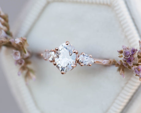 Oval moissanite three stone engagement ring, pear side stone